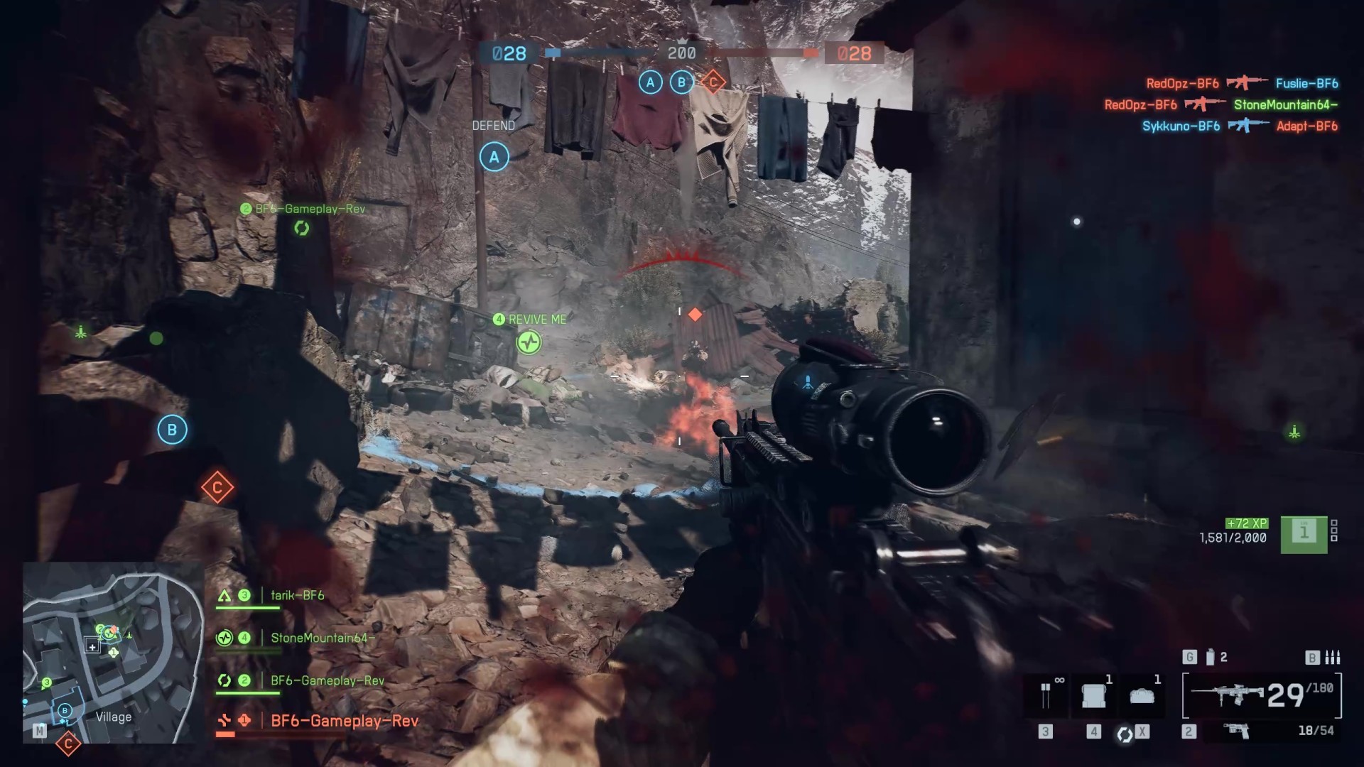 Moving through an alley alongside a cliff face in Battlefield 6 as fire blaze