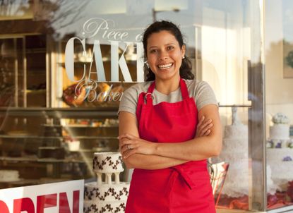 Hispanic female business owner outside her pastry shop