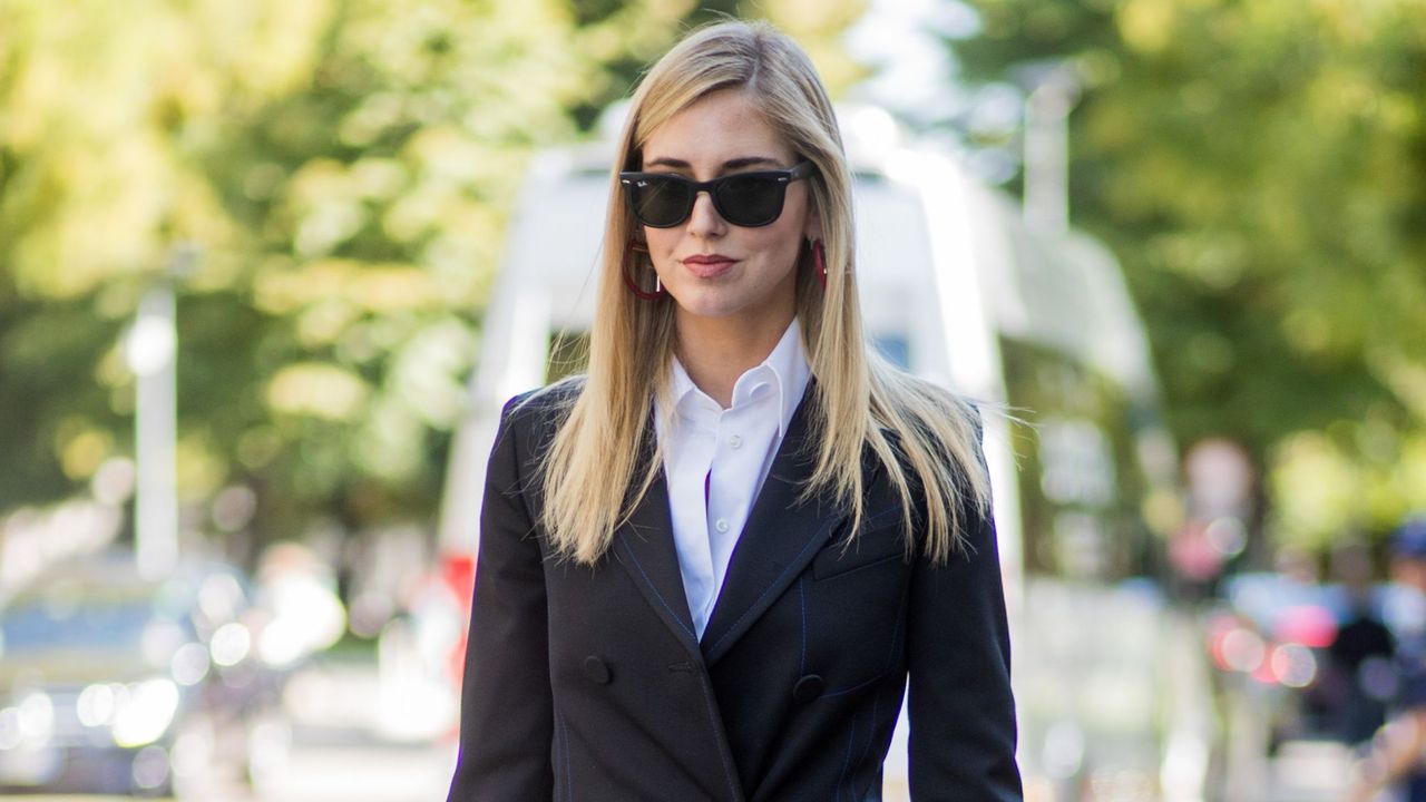 chiara ferragni wearing a double breasted black blazer, white shirt, black sunglasses and sleek straight hair - best hair straighteners