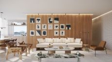 A chic and stylish home with a cream sofa and artwork behind it