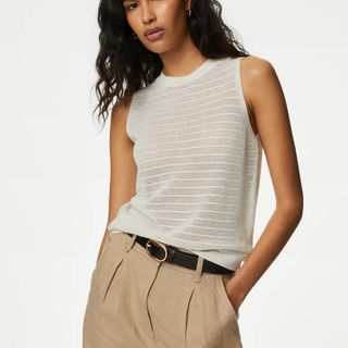 Model wearing M&S knit vest with beige trousers and brown belt