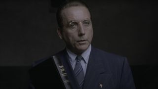 Bob Gunton holds a bible while in mid-speech in The Shawshank Redemption.