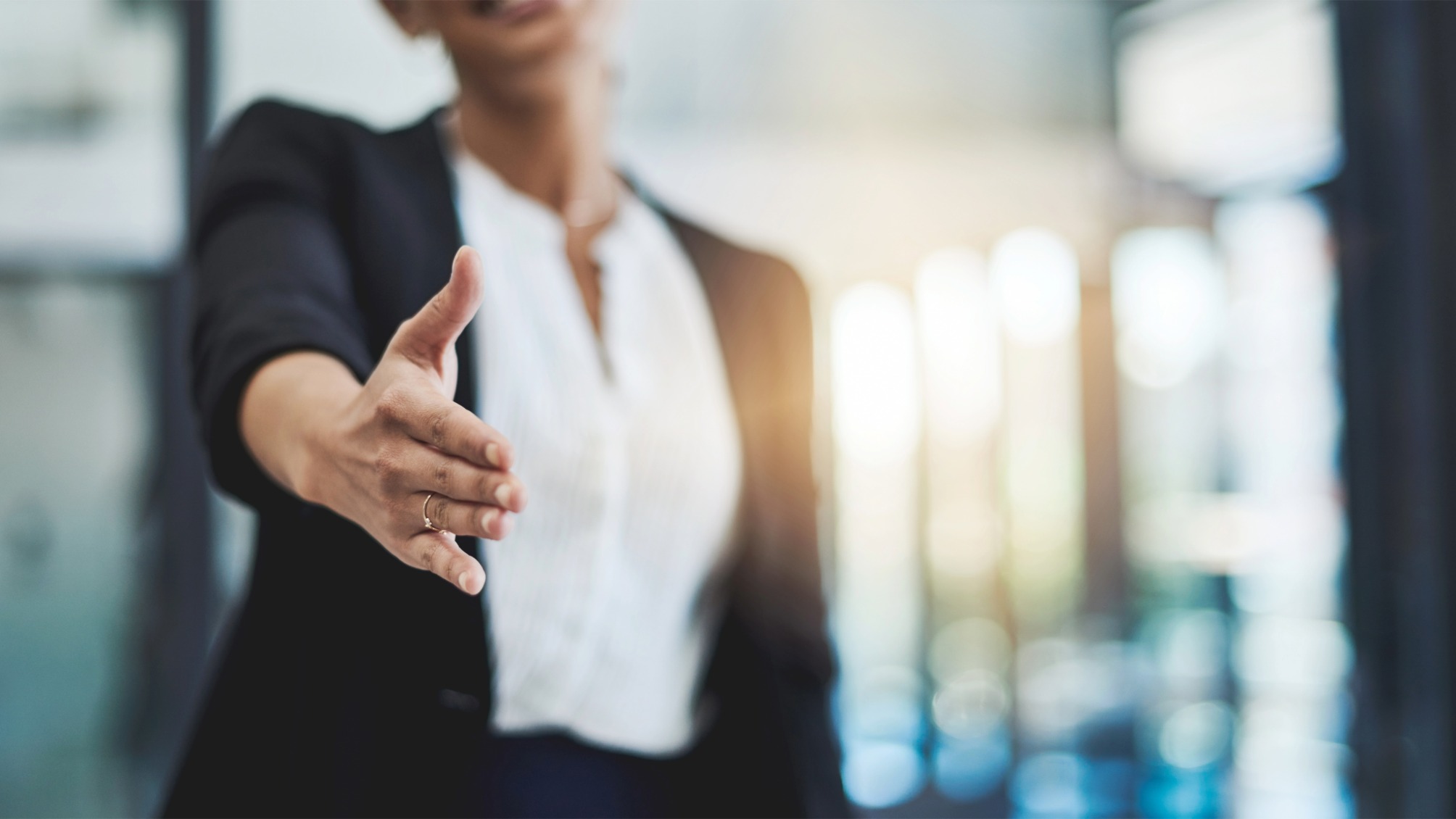 Cropped shot of a businesswoman extending her arm for a handshake
