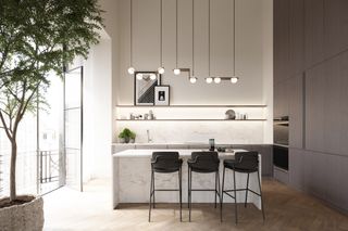 Kitchen with white marble island, three black chairs, potted plant, white glass cupboards, sink and stove.