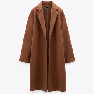 style a gilet over a tailored coat like this tan coat from Zara