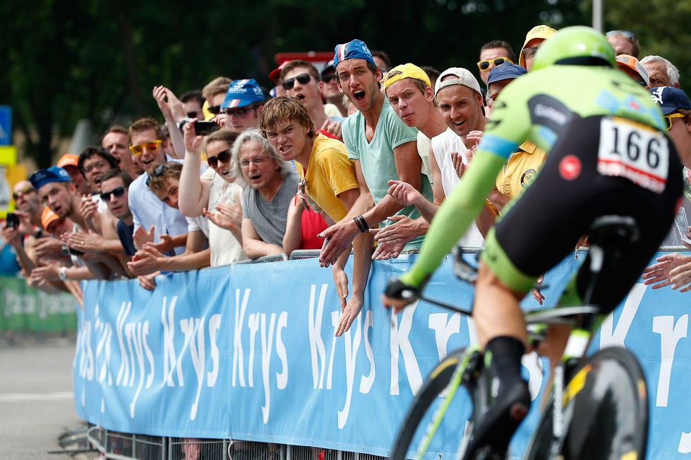 A Cannondale-Garmin rider receives support from spectators along the route.