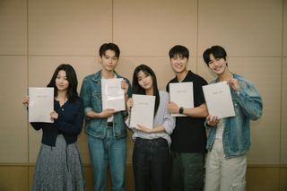 The cast of 'Love Untangled' poses while holding up scripts.