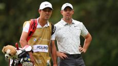 Rory McIlroy of Northern Ireland looks across the 15th hole with his caddie, Harry Diamond, during Day Three of the BMW PGA Championship at Wentworth Golf Club