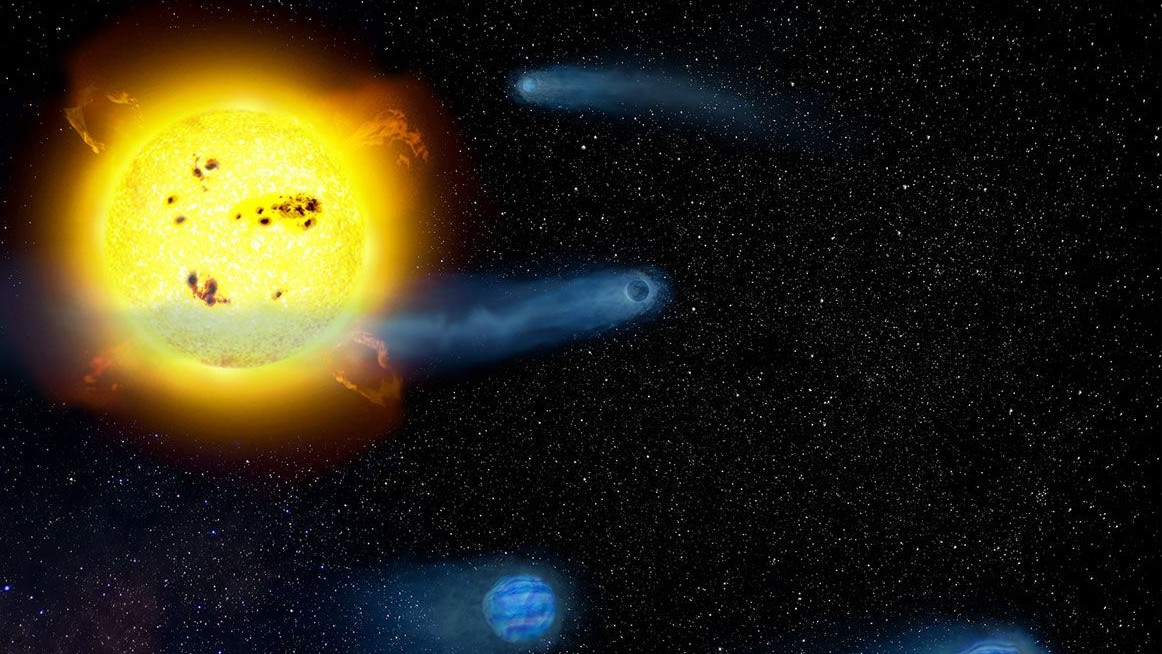 An illustration of four blue protoplanets swirling around a young yellow star