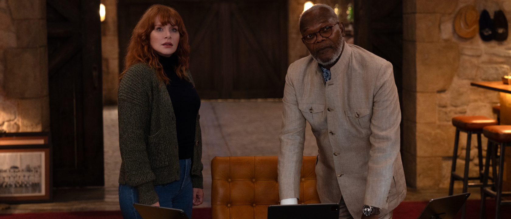 Bryce Dallas Howard and Samuel L. Jackson stand together at a desk in Argylle.