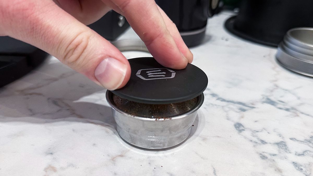 The Wacaco Picopresso tamp being used to tamp with the dosing funnel removed
