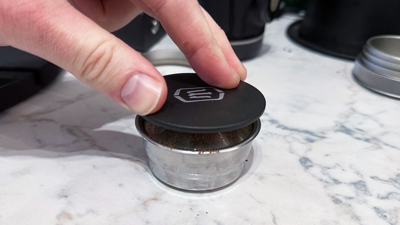 The Wacaco Picopresso tamp being used to tamp with the dosing funnel removed