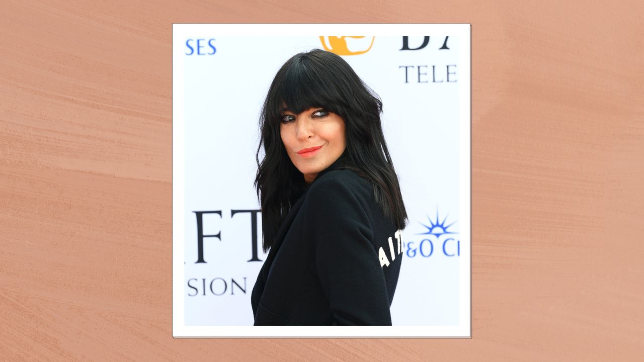 Claudia Winkleman is pictured wearing coral lipstick and a black blazer at the 2023 BAFTA Television Awards with P&amp;O Cruises at The Royal Festival Hall on May 14, 2023 in London, England/ in an orange template