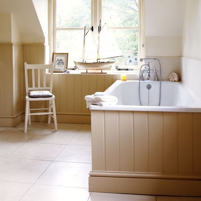 bathroom with bathtub and panelled wall