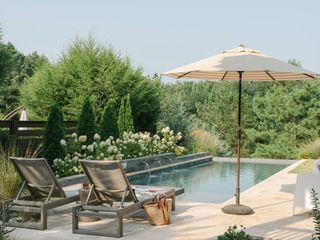 plunge pool with hydrangeas and garden furniture