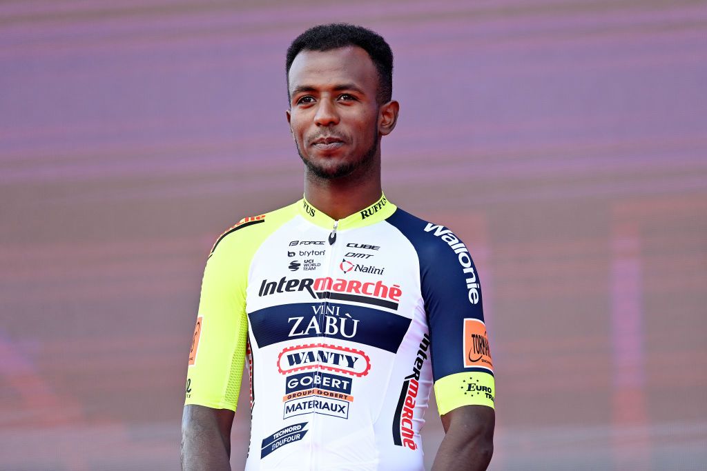 Biniam Girmay shows the latest sponsor for Intermarché, Vini Zabú, at Giro team presentation