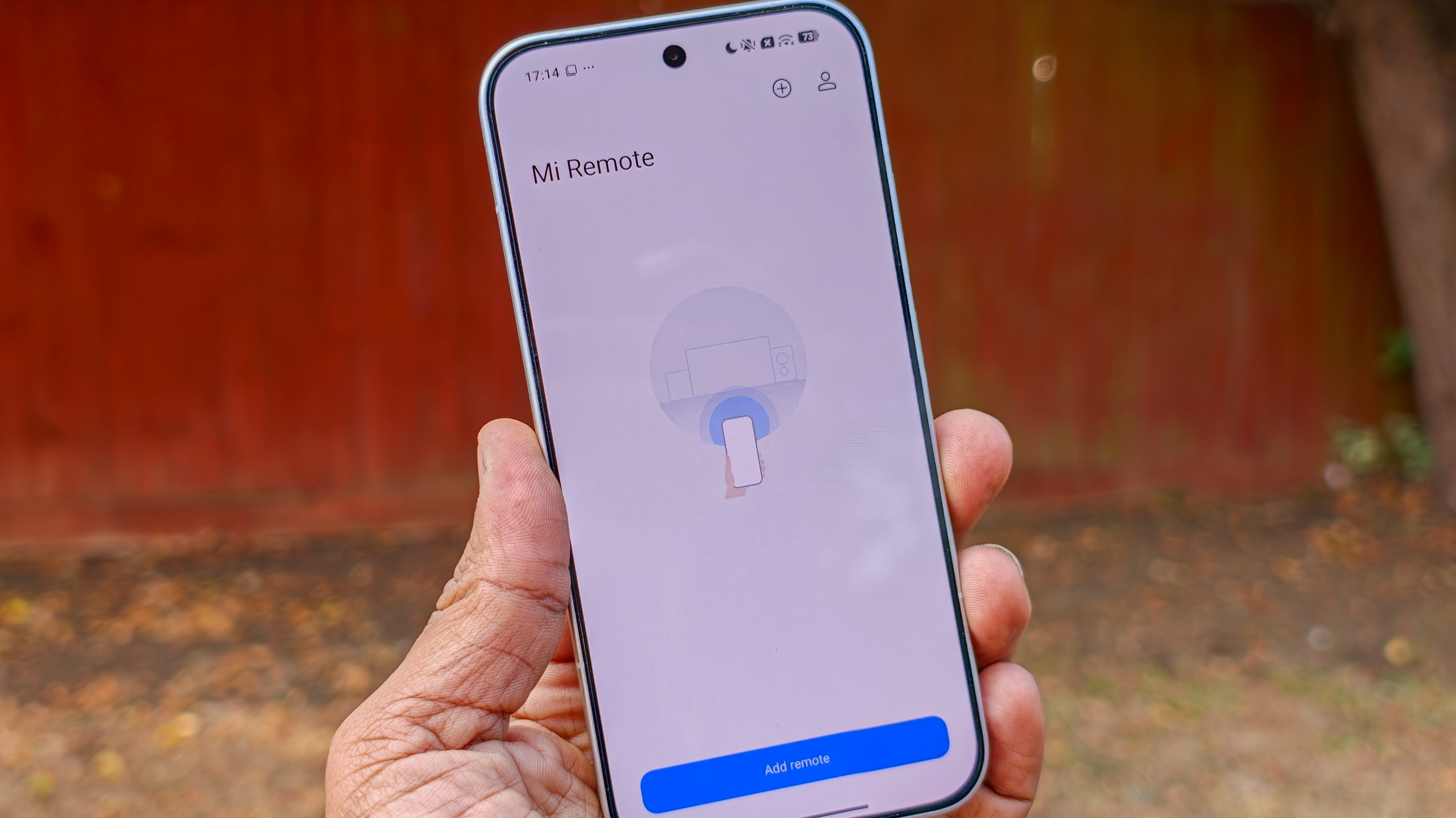 The Poco F8 Pro in Silver in the hand against a garden backdrop