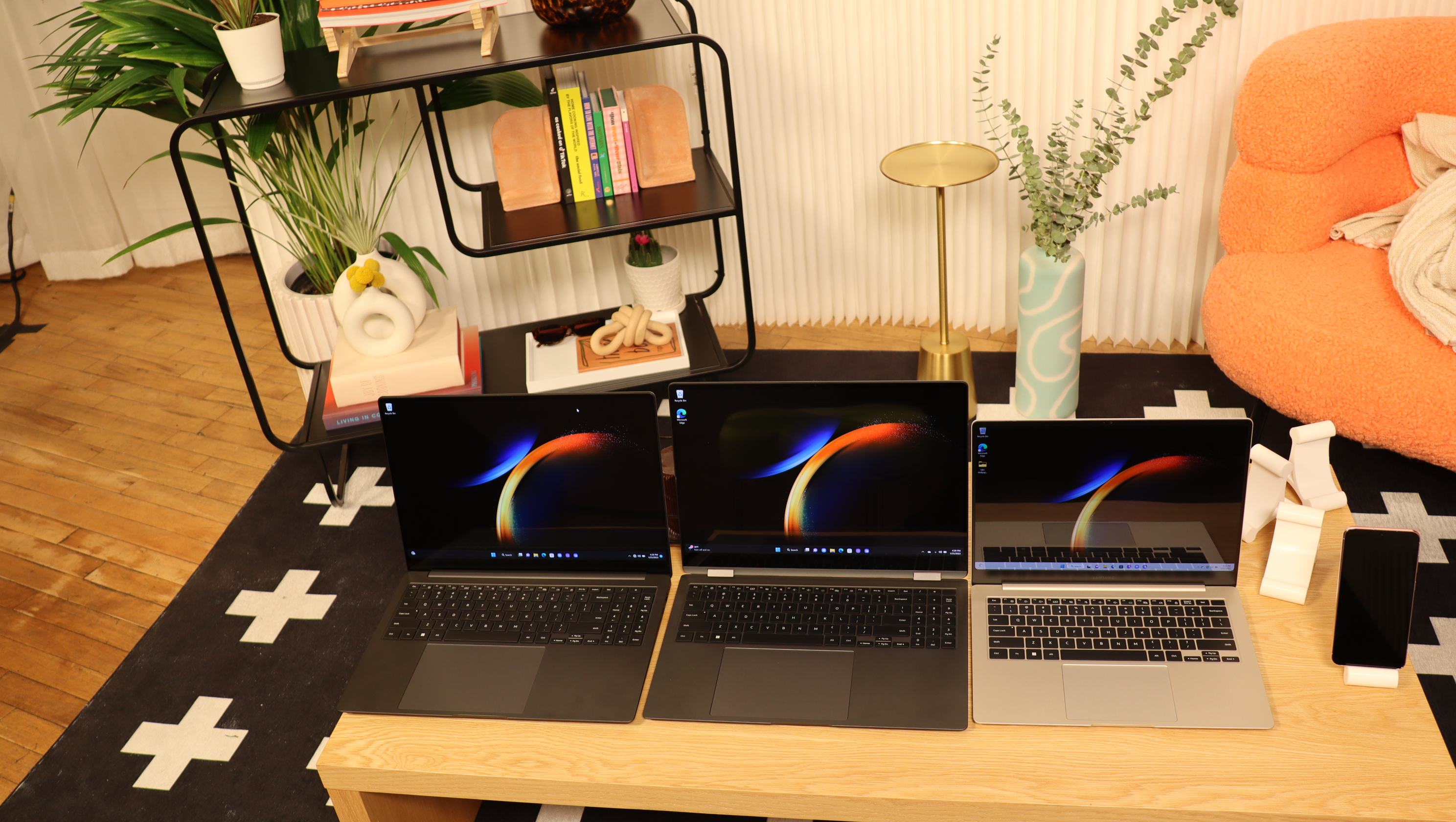 Three Samsung Galaxy Book3 sat next to each other on a wooden table