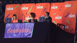 From left, Nate Burleson, Gabrielle Nevaeh Green and Noah Eagle work the Nickelodeon booth for the Saints-Bears playoff game.