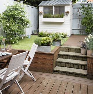 garden decking with steps leading up to the lawn