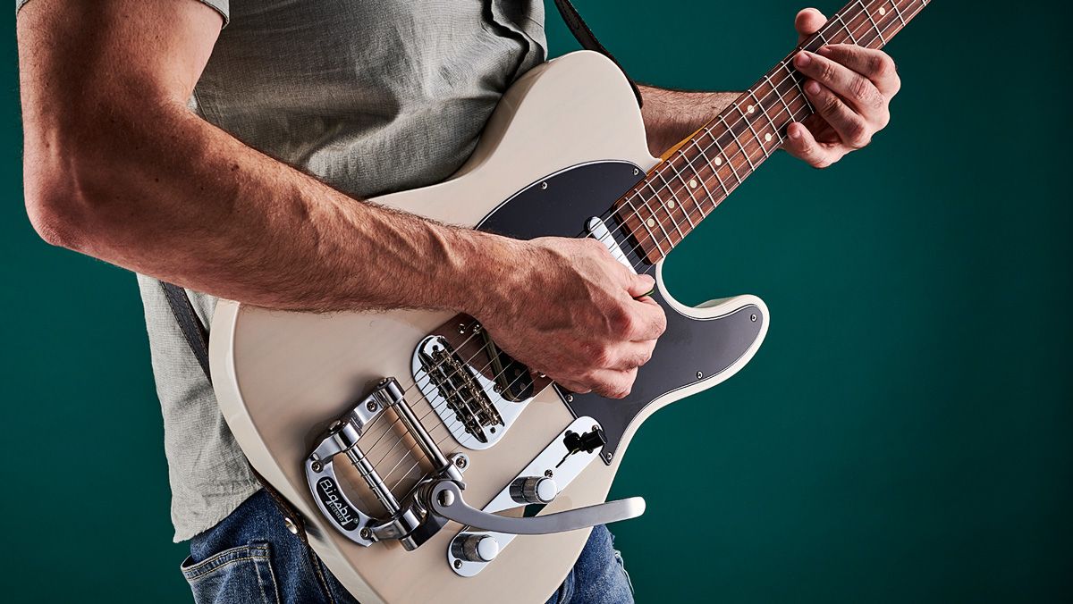 Man plays Telecaster electric guitar with Bigsby vibrato