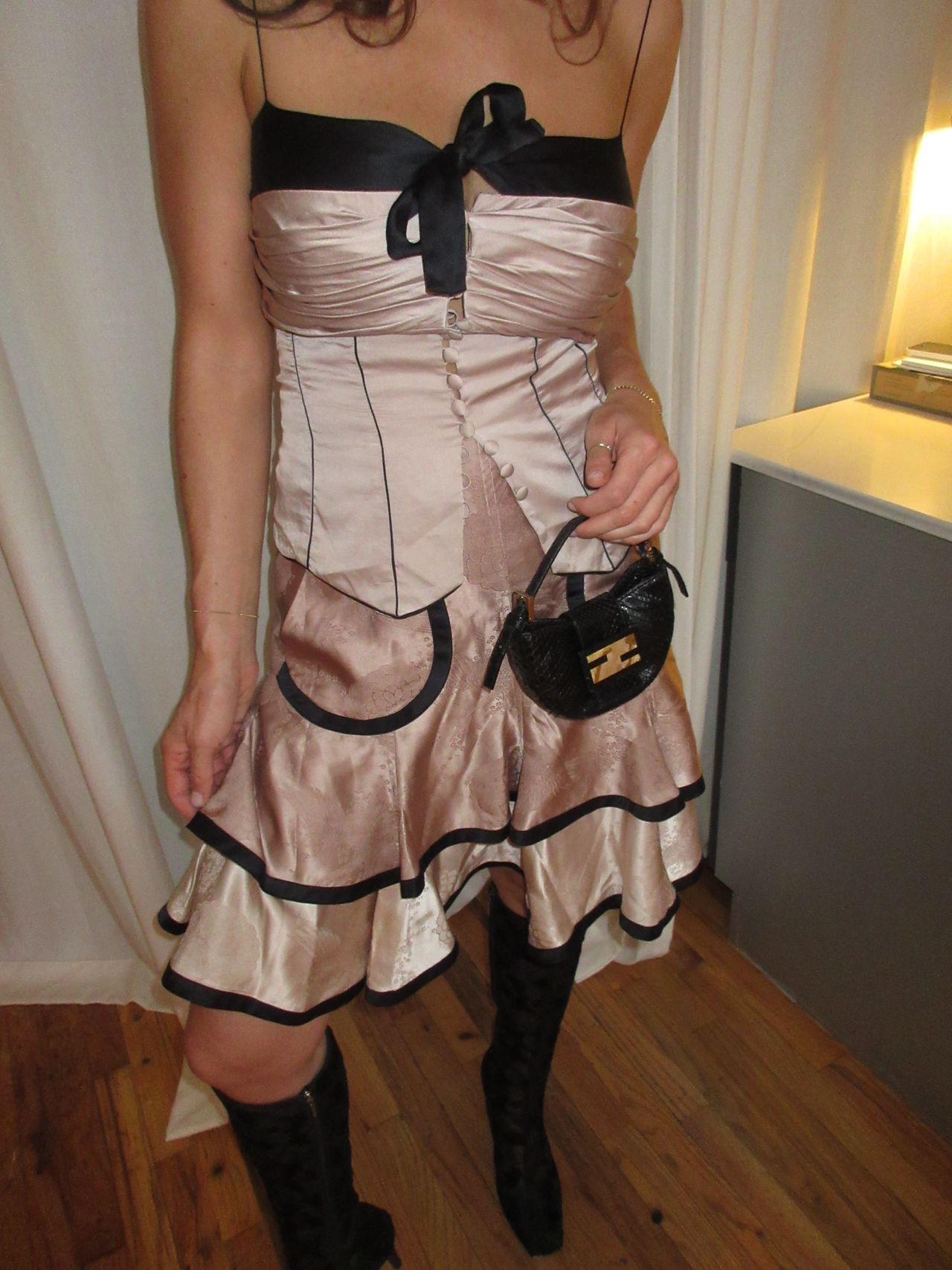 kathryn zahorak wearing pink and black satin top and skirt with black lace boots