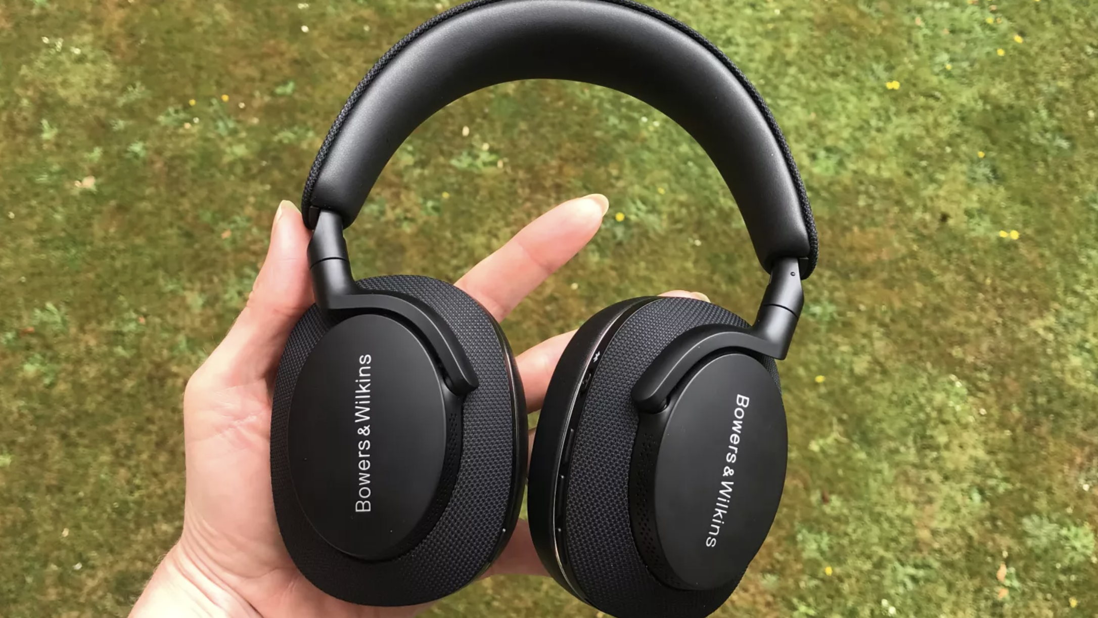 The Bowers & Wilkins PX7 S2 headphones on a grass surface