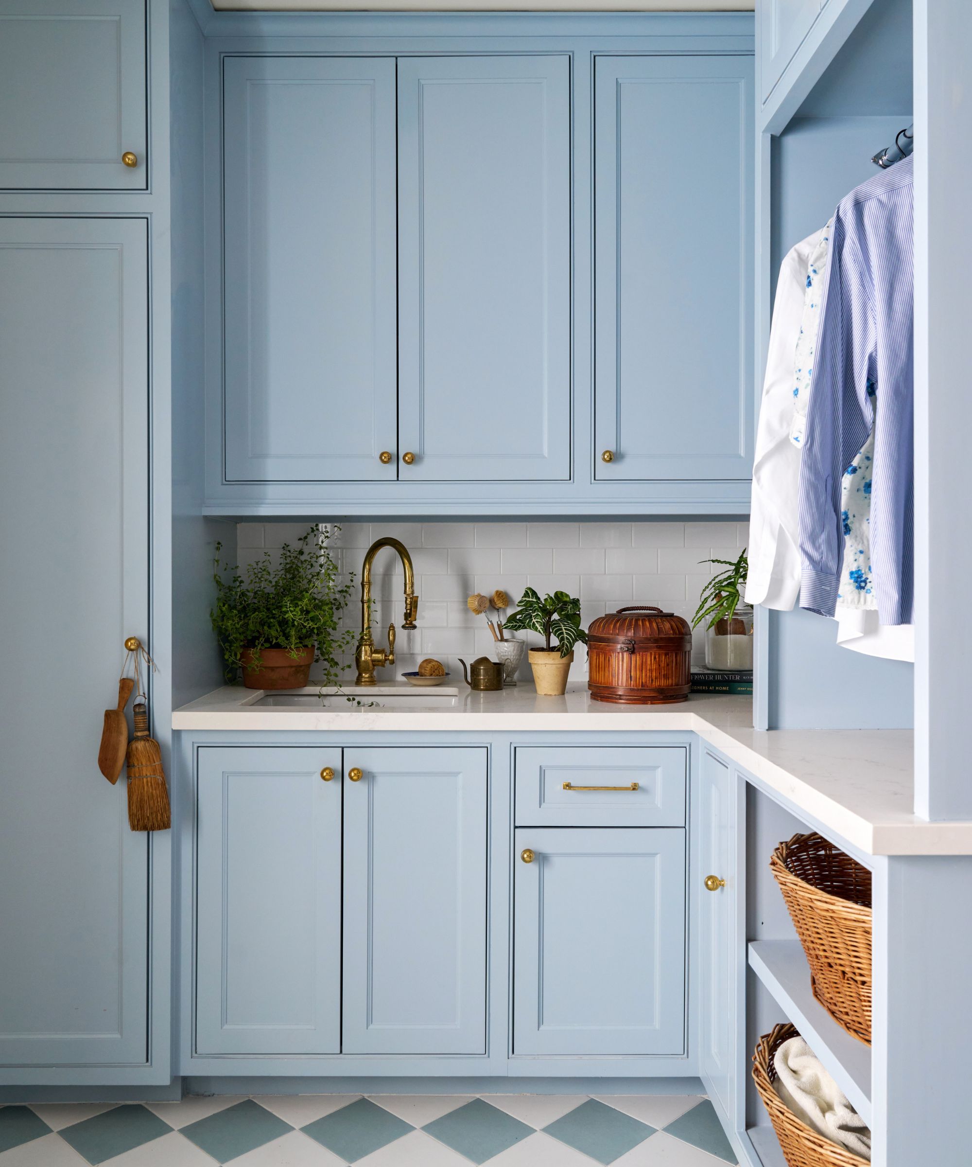 Pale blue laundry room with checked floor and white worktop