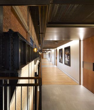 Wooden and steel corridor with doors off it