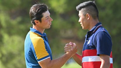 Viktor Hovland and Collin Morikawa shake hands