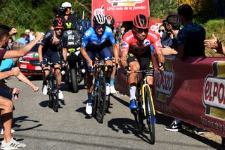 MOS SPAIN SEPTEMBER 04 Primoz Roglic of Slovenia and Team Jumbo Visma red leader jersey competes ahead of Enric Mas Nicolau of Spain and Movistar Team and Adam Yates of United Kingdom and Team INEOS Grenadiers in the chase group during the 76th Tour of Spain 2021 Stage 20 a 2022km km stage from Sanxenxo to Mos Alto Castro de Herville 502m lavuelta LaVuelta21 on September 04 2021 in Mos Spain Photo by Tim de WaeleGetty Images