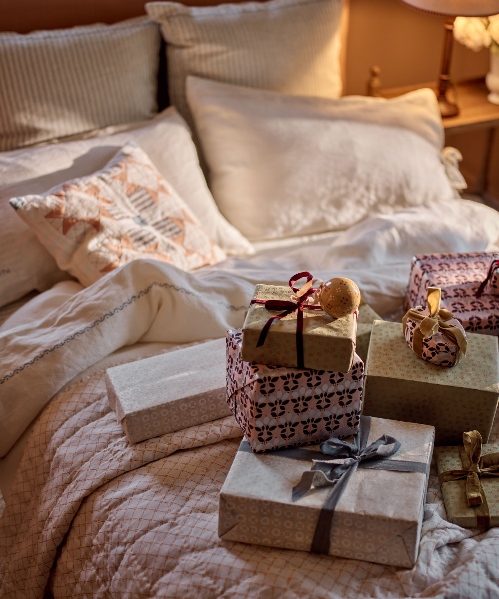 rowen &amp;amp; wren christmas advertorial - bed with wrapped christmas presents and baubles