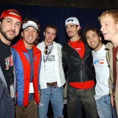 Smile, Cap, Social group, Jeans, Denim, Jacket, Winter, Facial hair, Cool, Friendship, 