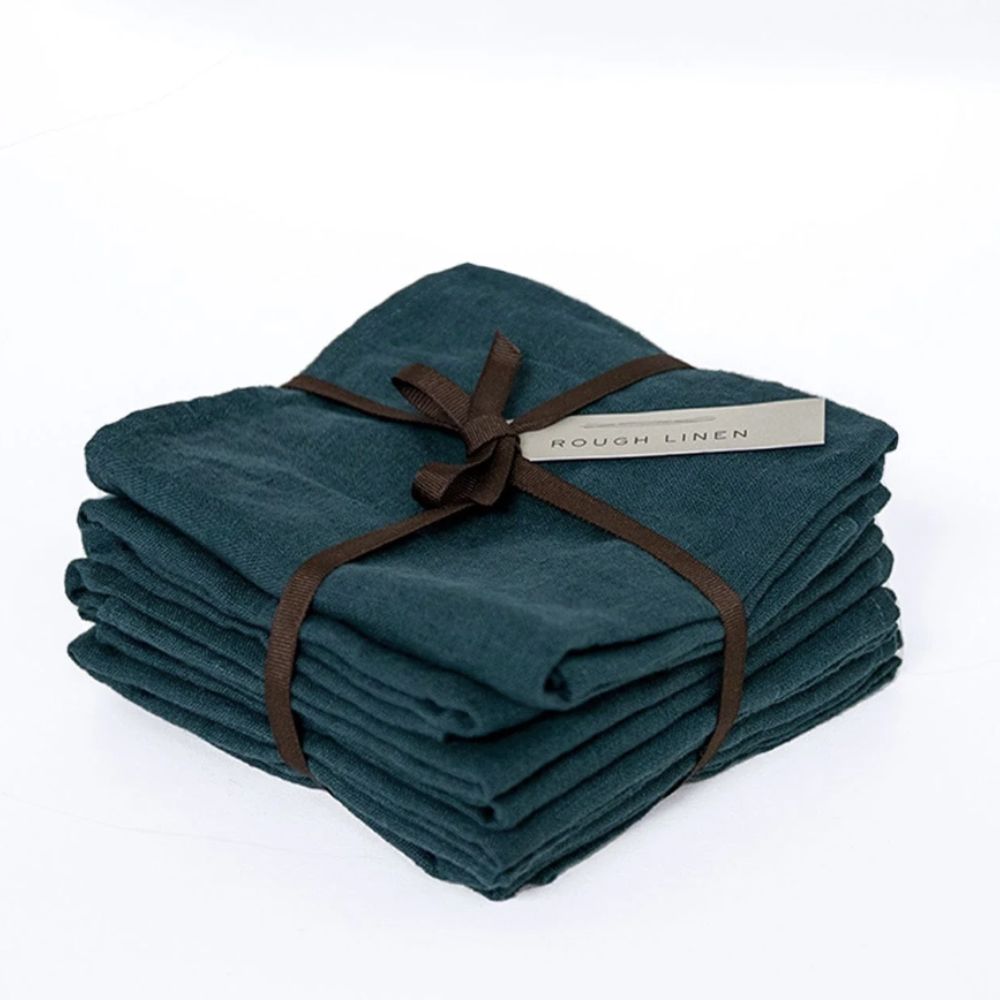 Pile of navy blue linen teatowels folded and tied with a ribbon 