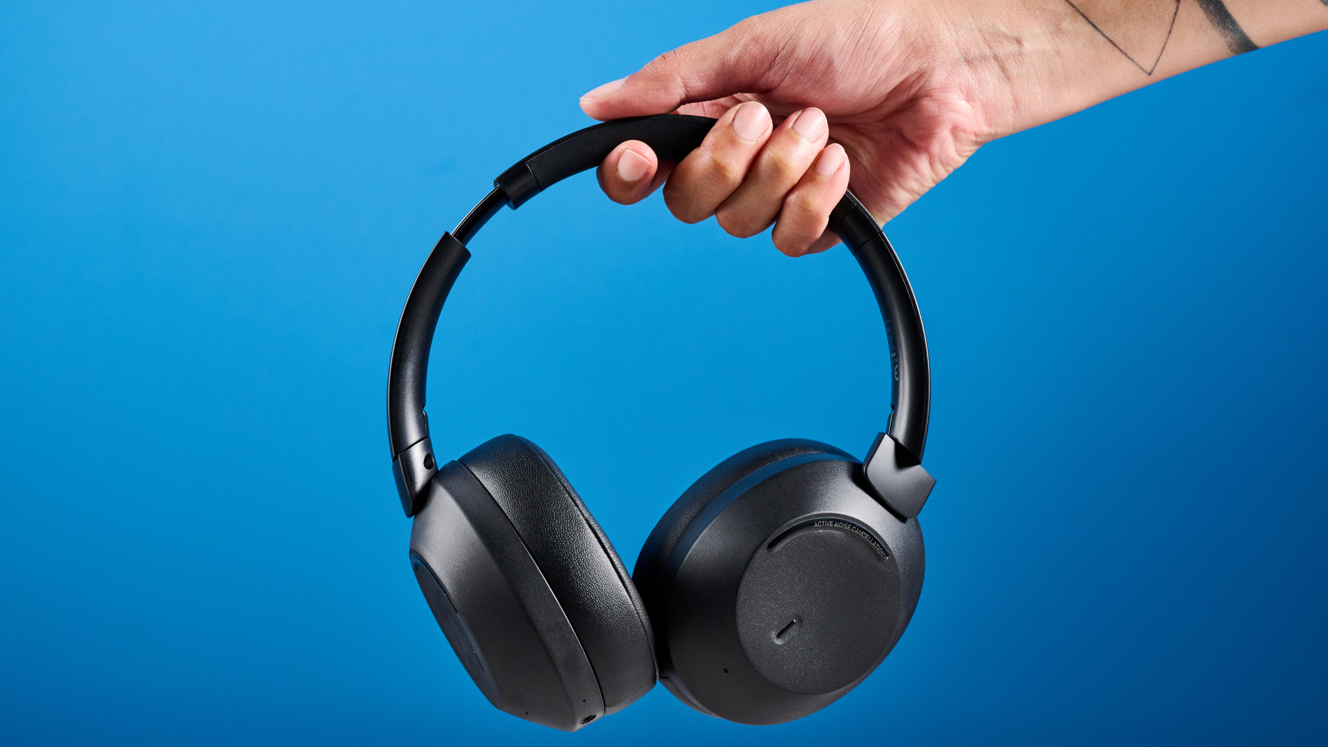 the mixx streamq c4 headphones in black with a blue background showing the soft cups and buttons controls