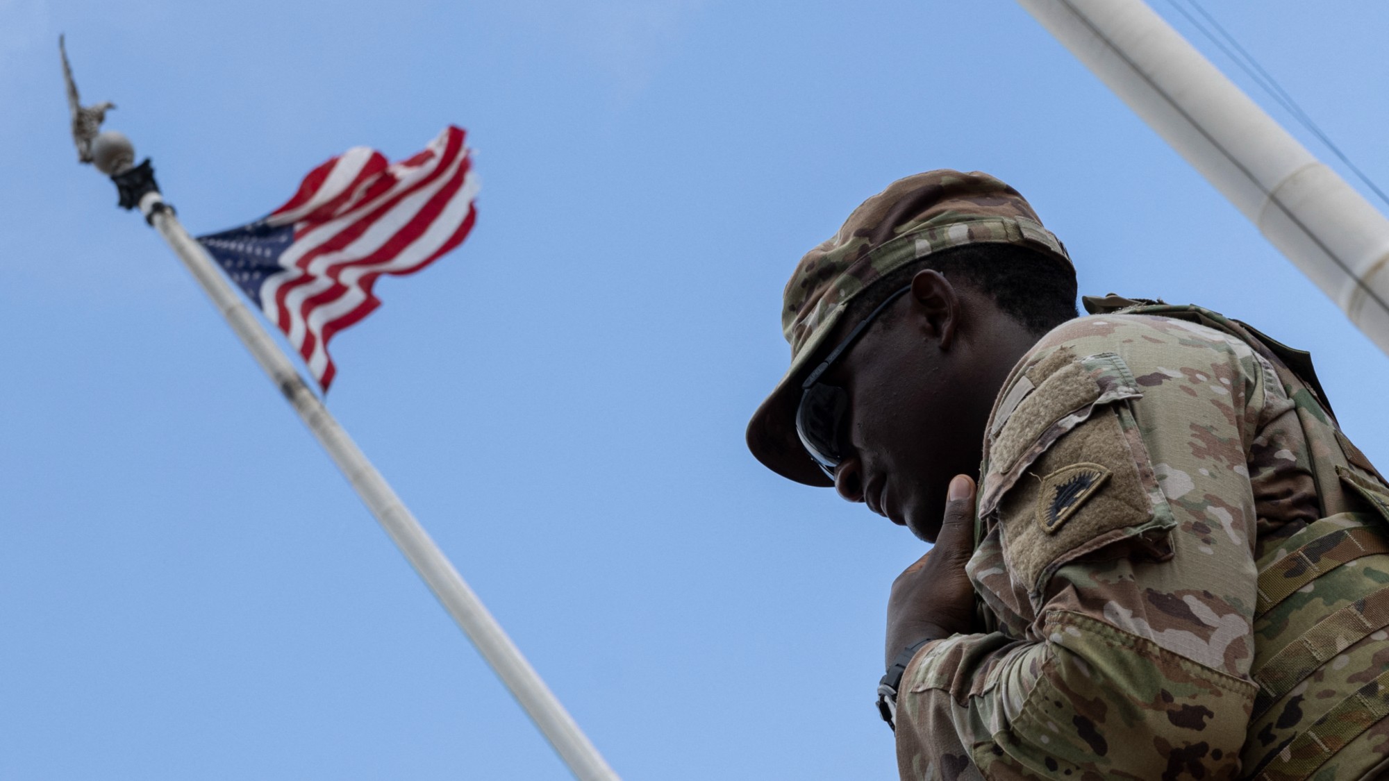 A soldier stands under an American flag near Union Station in Washington, D.C. 