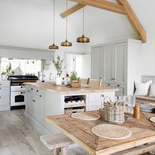 open plan kitchen with island unit and wooden dining table