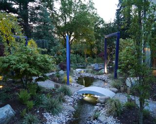 modern blue pergola in rock garden