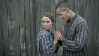 Anna Próchniak and Jonah Hauer-King as concentration camp inmates Lale Sokolov and Gita Furman in The Tattooist of Auschwitz 