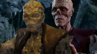 Withers touches the shoulder of his terrible miniature with a mournful expression.