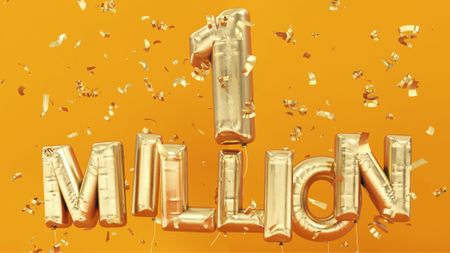 Gold helium balloons spelling out one million surrounded by confetti
