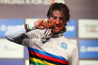 Peter Sagan takes a bite of his gold medal at the UCI Road World Championships in Richmond.