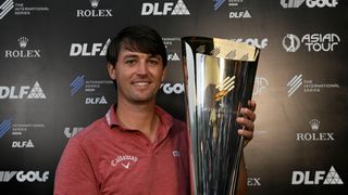 Ollie Schniederjans poses with the International Series India trophy after winning in 2025