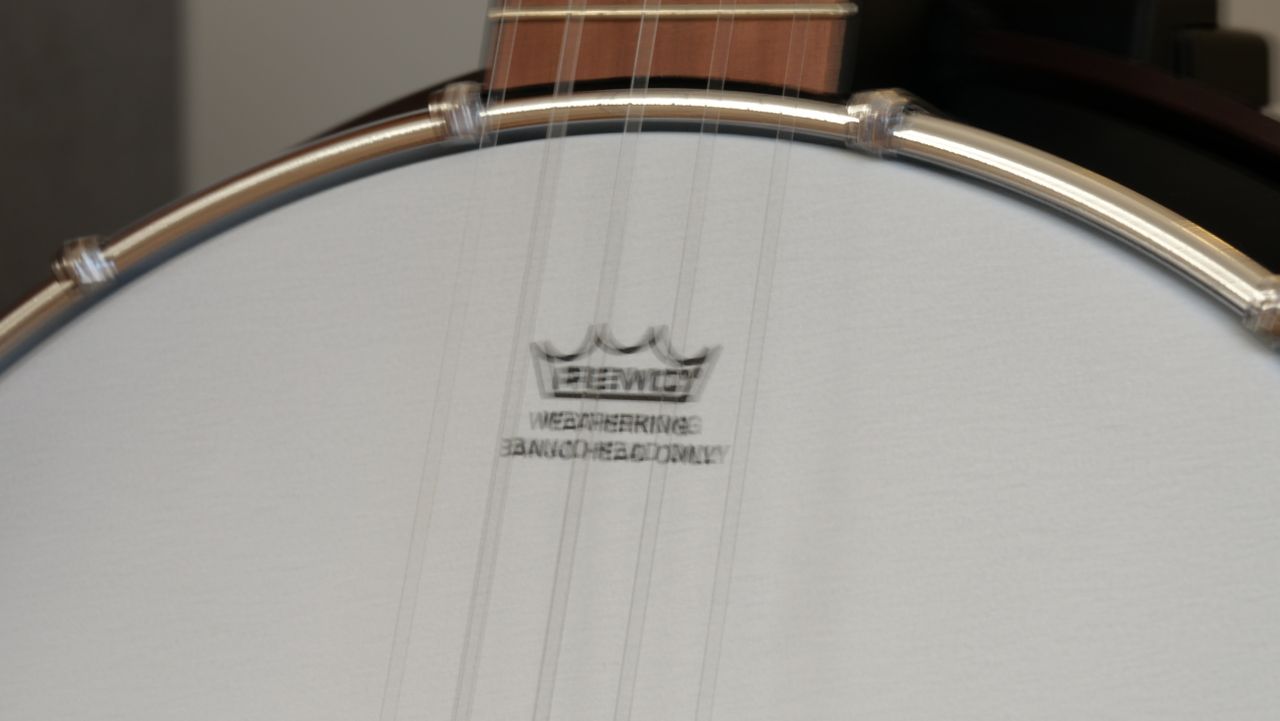 A photograph of a banjo head taken on the Lumix G97. Taken at 1/5 sec, the text on the banjo head is blurred.