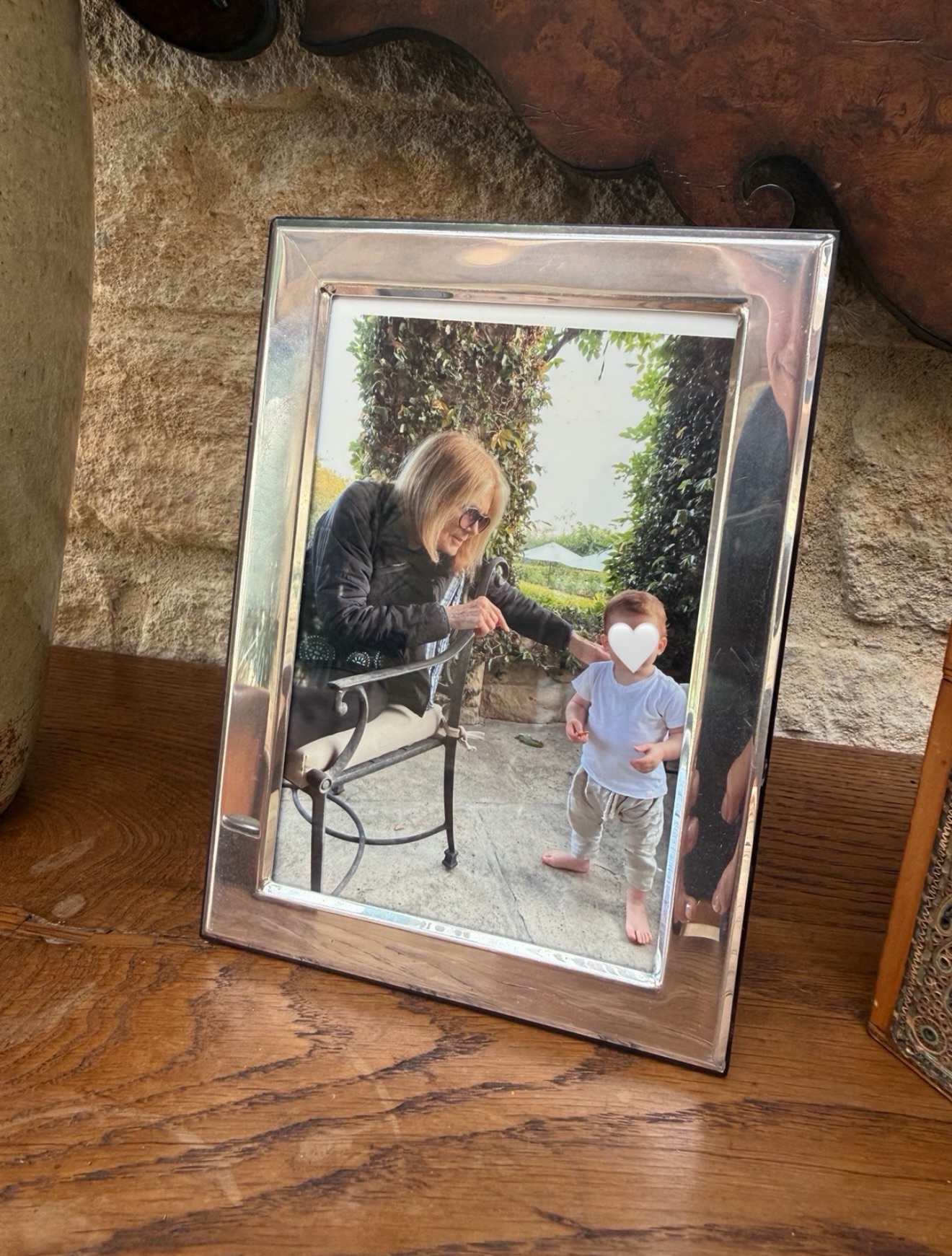 A framed photo of Prince Archie and Gloria Steinem sitting on a wood table
