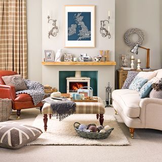 living room with carpet flooring, white sofa with cushions and fire place