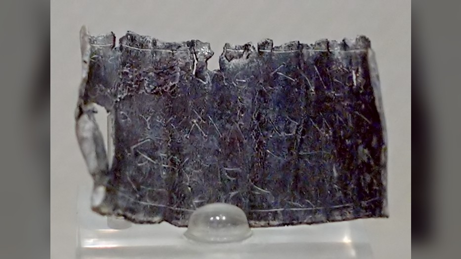 The curse on this lead tablet is written in Greek against someone called Kardelos. It dates from the fourth century A.D. and was found in a room in ancient Rome that held funerary urns.