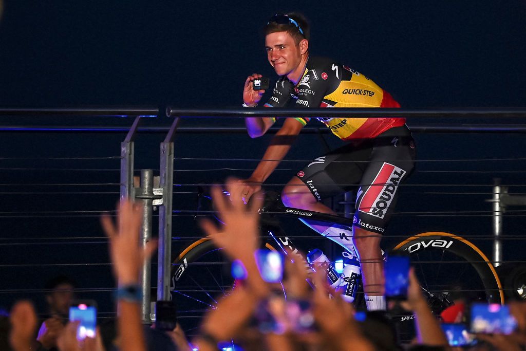 Team Soudal QuickStep Belgian rider Remco Evenepoel records a video as he takes the stage on his bike during the official teams presentation of the 78th edition of La Vuelta cycling tour of Spain in Barcelona on August 24 2023 Photo by Pau BARRENA AFP Photo by PAU BARRENAAFP via Getty Images