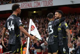 Douglas Luiz of Aston Villa celebrates scoring their side's first goal with teammate Philippe Coutinho and Boubacar Kamara during the Premier League match between Arsenal FC and Aston Villa at Emirates Stadium on August 31, 2022 in London, England.