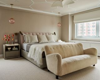 neutral bedroom with vintage Fritz Hansen sofa and pink glass pendants